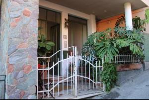 a house with a gate in front of a building at Casa Mina in Taormina