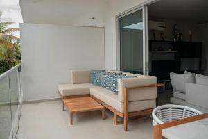 a living room with a couch and a table at Morros Vitri Beachfront By Huespedia in Bolivar