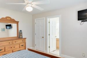 a bedroom with a bed and a ceiling fan at Oceans Edge in Nags Head