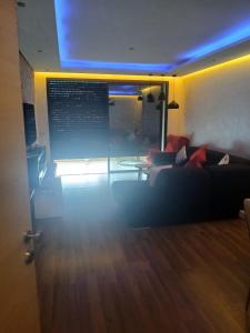 a living room with a couch and a table at Prestigia plage des Nations in Sale