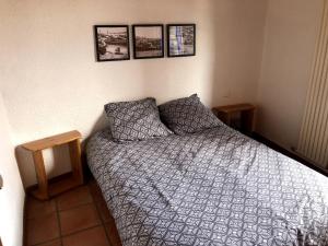 a bedroom with a bed and pictures on the wall at Appartement Les Angles villages in Les Angles