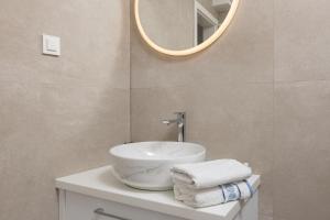 a bathroom with a sink and a mirror at Apartments Amfora 2 in Podgora