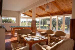 a living room with couches and a pool table at La Elvira Natural Lodge Nature & Wildlife Experience in Península Valdés in Punta Delgada