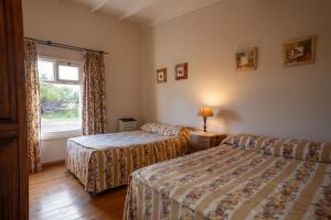 Ένα ή περισσότερα κρεβάτια σε δωμάτιο στο La Elvira Natural Lodge Nature & Wildlife Experience in Península Valdés