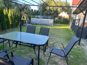 a table and chairs in a backyard with a playground at Villa Kraków in Kraków