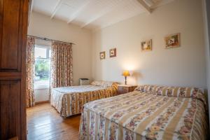 a hotel room with two beds and a window at La Elvira Natural Lodge Nature & Wildlife Experience in Península Valdés in Punta Delgada
