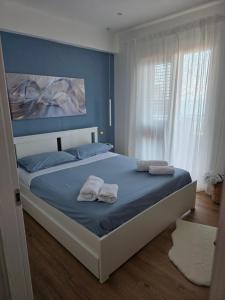 a bedroom with a bed with two towels on it at Giaele Home in Letojanni