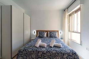 a bedroom with a bed with two pillows at EL destello del Faro penthouse in Torrox