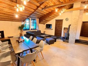 a large living room with a table and chairs at Apartmány Miláček 