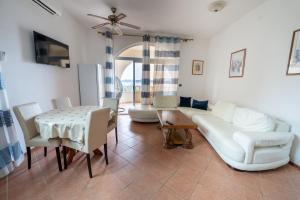 een woonkamer met een bank, een tafel en stoelen bij Beach Apartments Villa Holiday in Živogošće