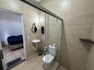 a bathroom with a shower and a toilet and a sink at Suites dos Laranjais in Olímpia +25 photos