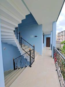 a staircase in a house with a blue wall at G guesthouse in Kobuleti