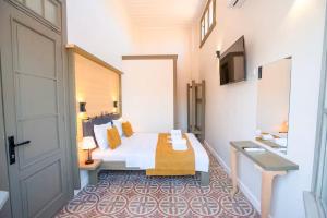 a hotel room with a bed and a door at Özel Otel in Ayvalık
