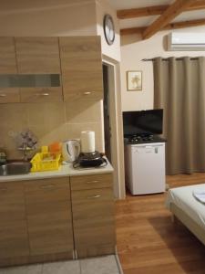 a kitchen with a sink and a counter top at Apartments Nenadić in Utjeha +51 photos