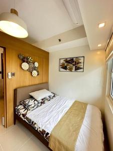 a bedroom with a bed in a room at Luxury staycation at prime location Mall of Asia Shell Residences Pasay Tower C in Manila +12 photos