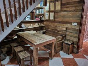 a kitchen with a wooden table and a staircase at Molino Romano in Alcalá del Valle