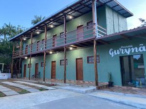 a building with a balcony on the side of it at Pousada Gurynã in Novo Airão +20 photos