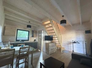a living room with a staircase in a house at Szare Domki in Mrzeżyno
