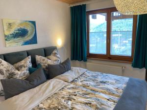 a bed in a bedroom with a window at Ferienwohnung mit Weitblick in Lambrecht