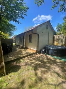 a house with a deck next to a building at Océan glamping in Messanges