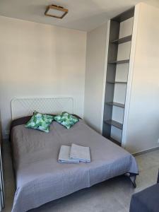 a bedroom with a bed with two pillows and a shelf at NWW Zgody 13 Warszawa Centrum in Skorka