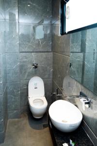 a bathroom with a toilet and a sink at Hotel RK Heights 300M HOTEL TO GOLDEN TEMPLE in Amritsar