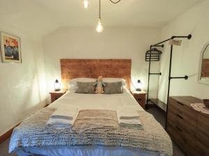 a bedroom with a large bed with a teddy bear on it at Fellside Cottage in Bowness-on-Windermere