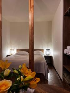a bedroom with a bed with yellow flowers on a table at Green Agarak 2 near Dendropark, Stepanavan in Gyulagarak