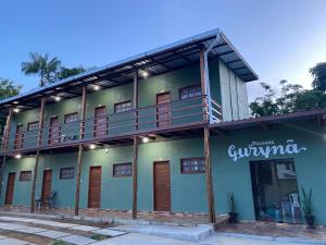 a building with a balcony on the side of it at Pousada Gurynã in Novo Airão
