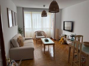 a living room with a couch and a table at La Piragua in Ribadesella