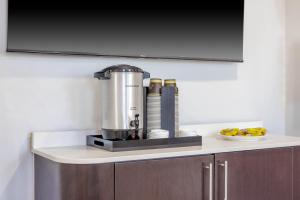 a blender on a counter with a plate of fruit at Studio 6 Toronto - Mississauga with Kitchenettes in Mississauga +38 photos