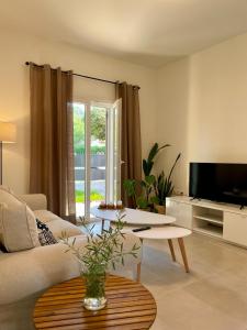 a living room with a couch and a table at Tati apartment 2 in Kassiopi