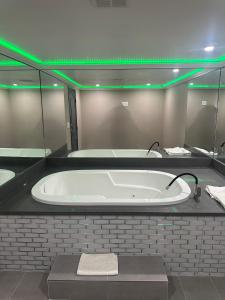 a large bath tub with green lights in a bathroom at Stardust inn in Azusa