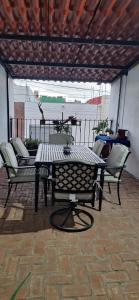 a patio with a table and chairs on a patio at Hotel de Guadalupe, Puebla in Puebla