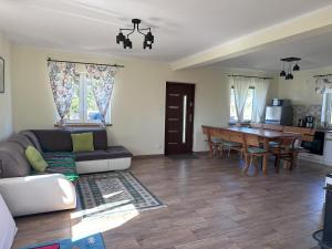 a living room with a couch and a table at Domek 8 osobowy in Wroceń