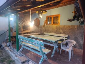 een houten tafel en een bank in een kamer bij Sarajevo Hills,small villa with garden and garage,OLD CITY in Sarajevo