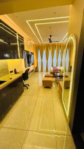 a living room with a couch and a desk at Chalo Chaley Luxury Stays in Ghaziabad