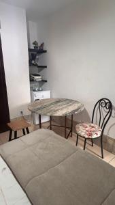 a dining room with a table and two chairs at Acomodação Bicentenária - qrts parte baixa da casa - Rua Casa da Ópera in Ouro Preto