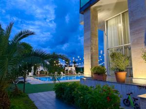 a house with a swimming pool at night at Hotel Aeetes Kobuleti in Kobuleti +23 photos