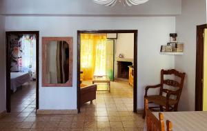 a living room with a chair and a mirror at Casa La Garganta, en plena naturaleza in Piedralaves