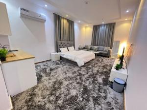 a living room with a bed and a couch at A privet room in AL Rawda in Quai