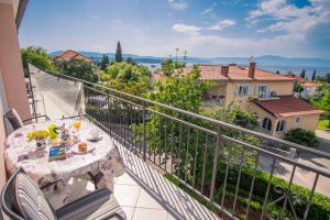 a table and chairs on a balcony with a view at Apartment Karamarko in Malinska