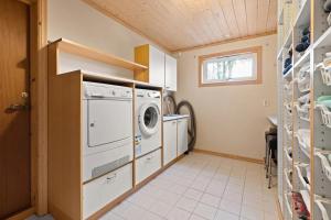 a laundry room with a washer and dryer at Whole Holiday Home in Asker