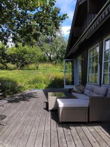 a porch with a couch on a wooden deck at Whole Holiday Home in Asker