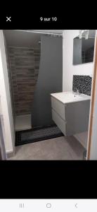 a bathroom with a sink and a white sink at La Cachette de la baie in Pontorson