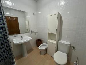 a white bathroom with a toilet and a sink at Villa Alcázar in San Pedro del Pinatar +11 photos