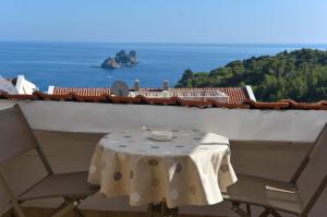 a table and chairs on a balcony with a view of the ocean at Vila Apartments Lidija in Petrovac na Moru