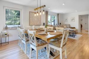 a dining room and living room with a table and chairs at Landhaus Schwerin in Kirch Jesar