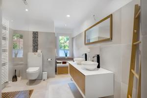 a white bathroom with two sinks and a mirror at Landhaus Schwerin in Kirch Jesar +49 photos