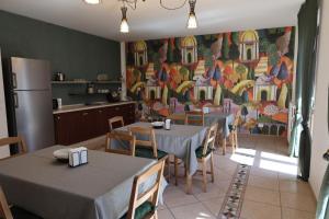 a kitchen with tables and chairs and a painting on the wall at B&B Da Fifi in Castel San Giorgio